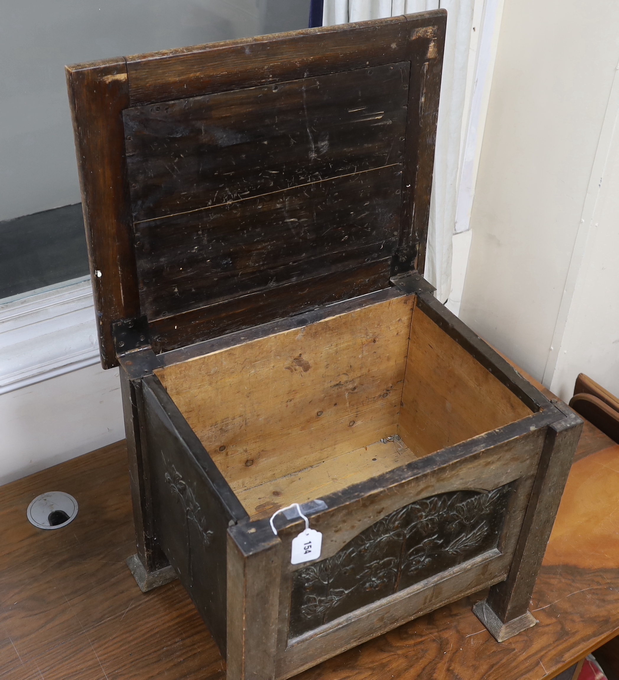 An Arts and Crafts oak and embossed copper coal box, width 54cm, depth 43cm, height 46cm